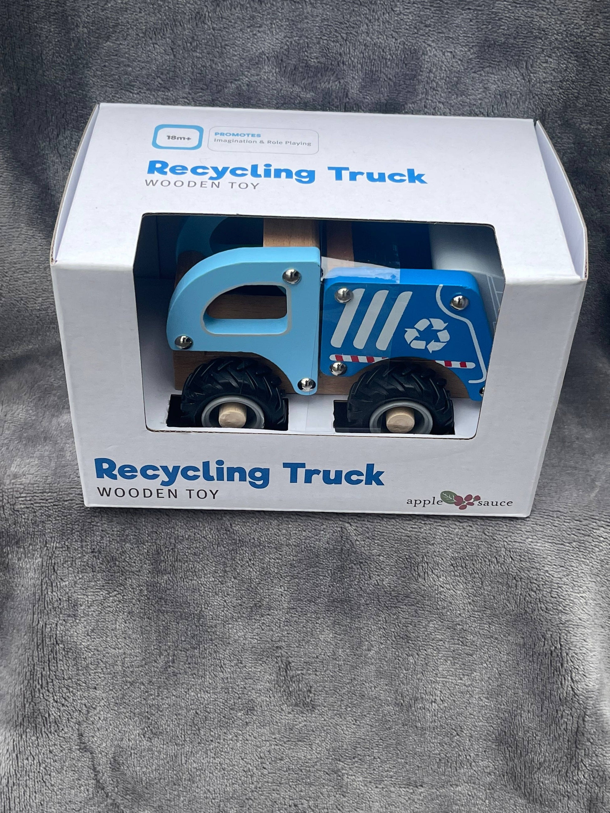 Wooden blue recycle truck with moveable parts to promote imagination and role playing.