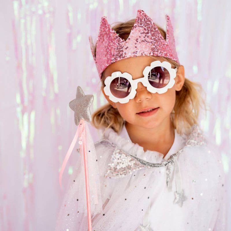 Little girl wearing pink sequin princess crown for dress up