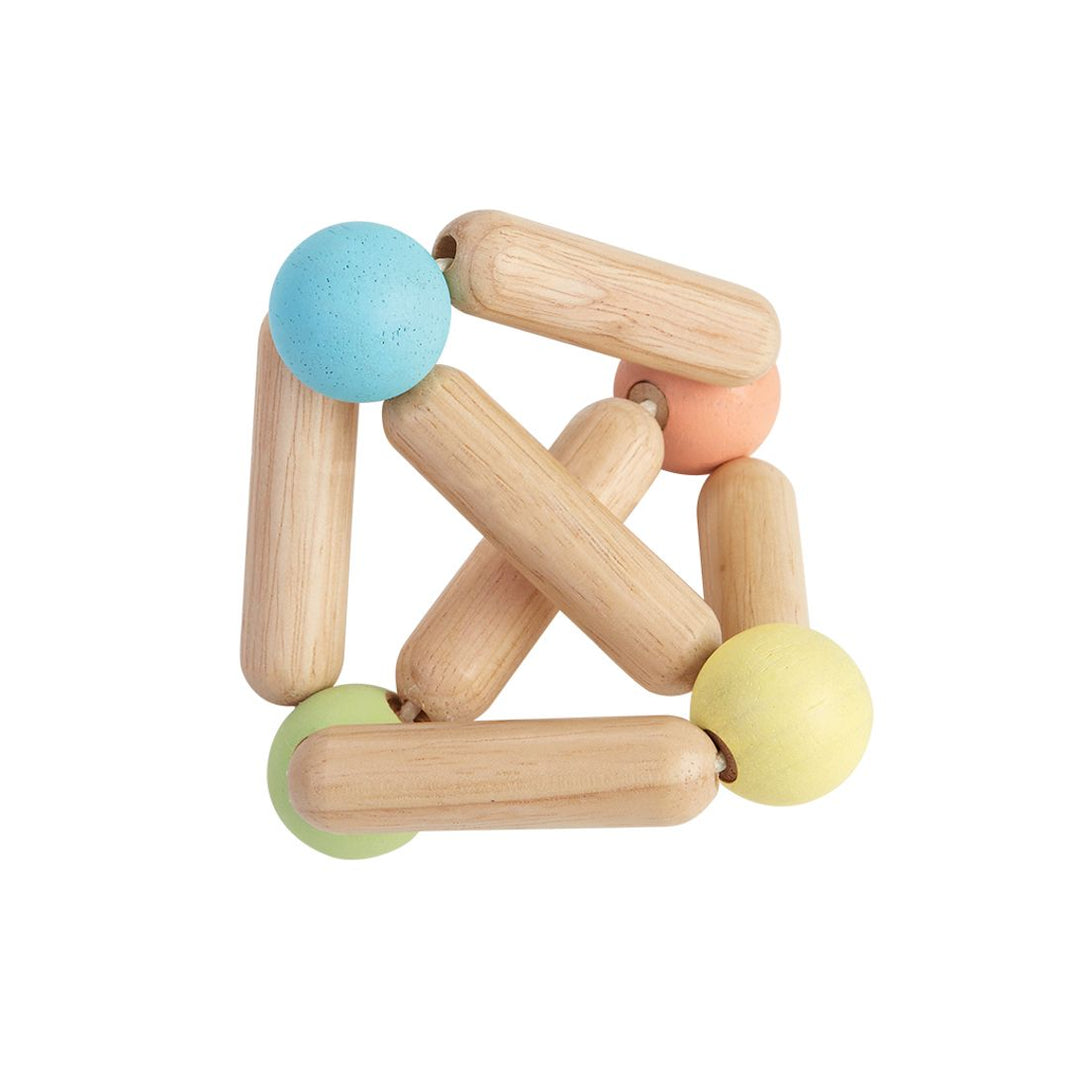 Plantoys brand Wooden Triangular shaped clutching baby toy with two toned ball in the center that can be removed for a rattle.