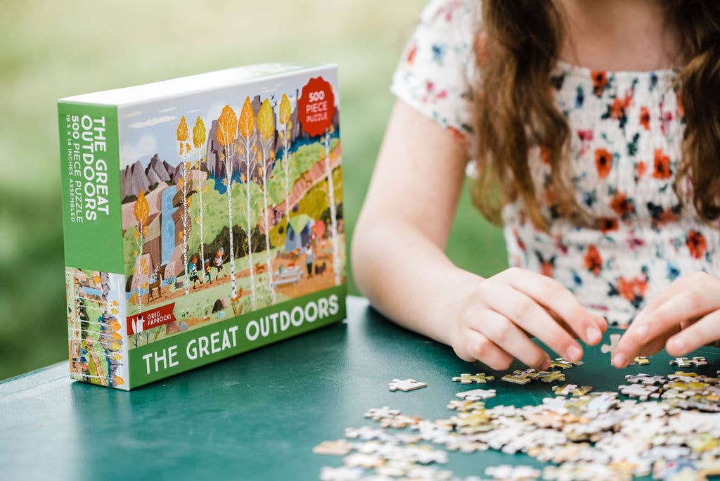 Camping puzzle with 500 pieces being played with outside