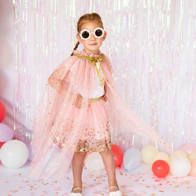 Girl wearing pink tulle and glitter star cape for party