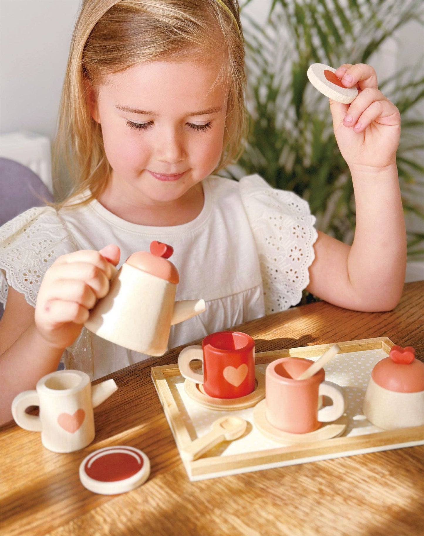 Mentari brand eco-friendly wooden tea set in natural colors with pink and red hearts for valentine's day.