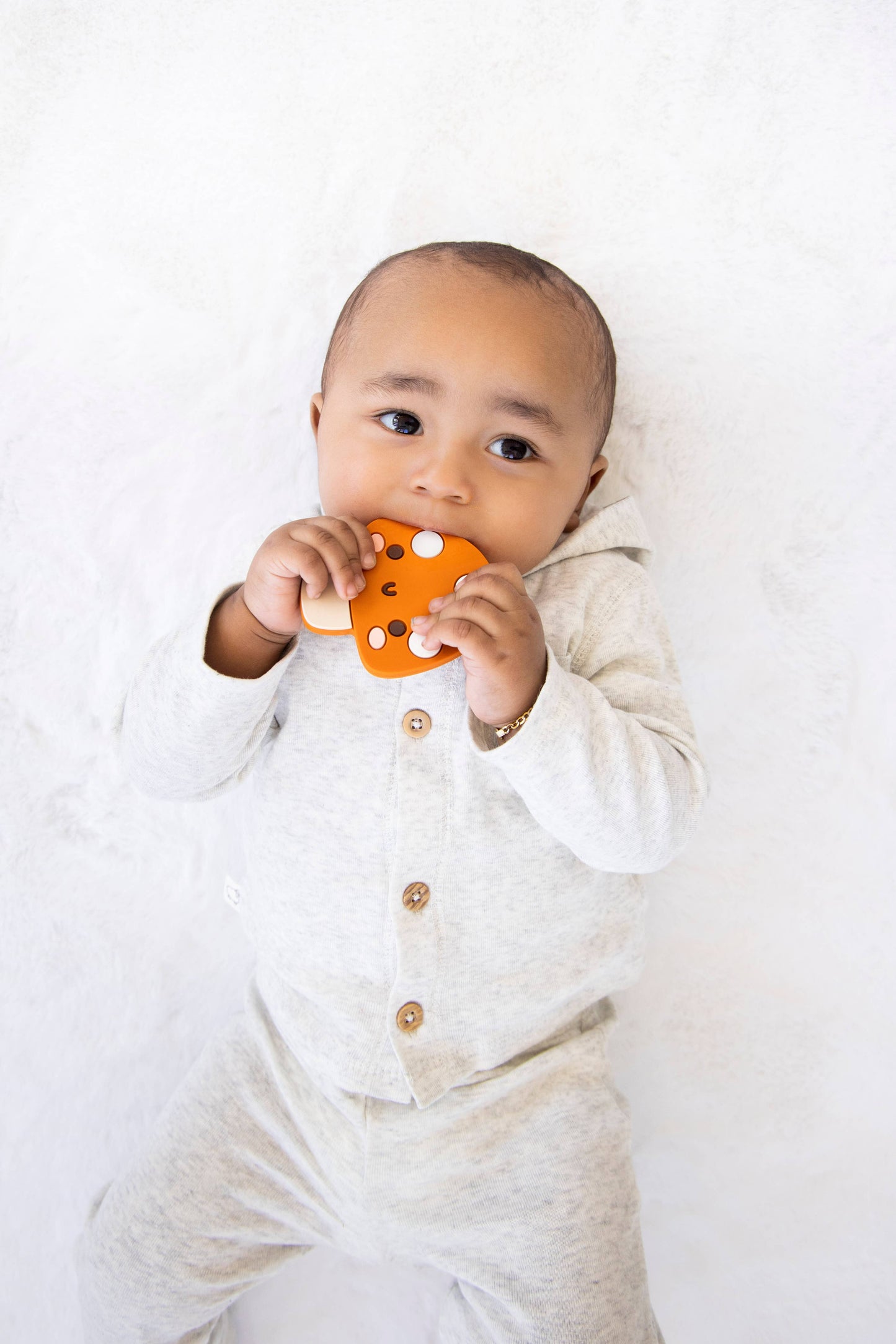 orange mushroom baby teether with smiley face is bpa free